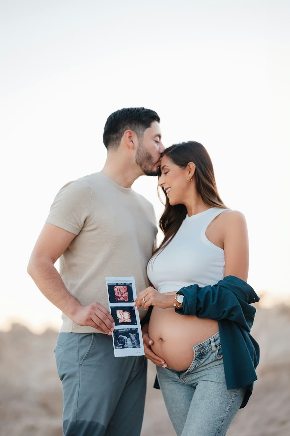 Una pareja que espera un bebé muestra la imagen de un ultrasonido.